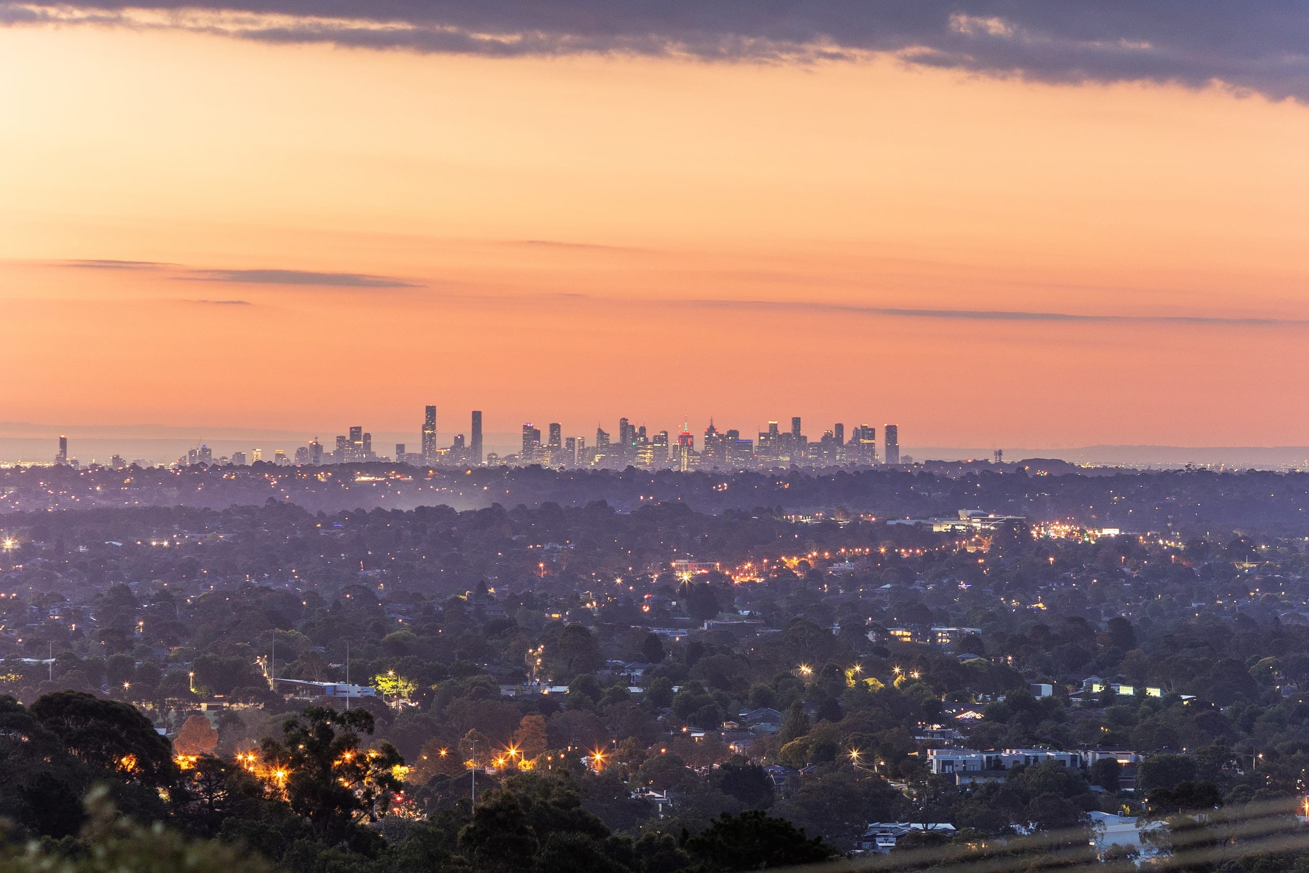 Dusk view from 30 Mercia Avenue across the lit-up suburbs to the city skyline
